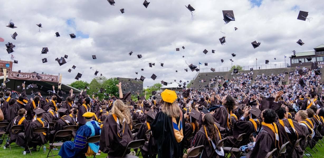 Graduates throwing their caps at commencement